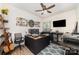 Functional office space featuring built-in desk, shelving, ceiling fan, and natural lighting at 6070 Trinity Crossing Cir, Kannapolis, NC 28081