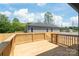 Open wood deck overlooks fenced backyard and home's exterior at 640 Central Nw Dr, Concord, NC 28027