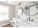 Bathroom vanity features double sinks, white cabinets, matte black fixtures, and round mirrors at 640 Central Nw Dr, Concord, NC 28027
