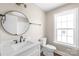Bathroom has white vanity, toilet, mirror, and trim with a neutral colored wall at 640 Central Nw Dr, Concord, NC 28027