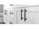 Close up of white bathroom cabinet with bold, black hardware at 640 Central Nw Dr, Concord, NC 28027