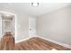 Bright bedroom boasts hardwood floors, white trim, and fresh neutral paint at 640 Central Nw Dr, Concord, NC 28027