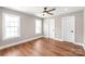 Light-filled bedroom features hardwood floors, a ceiling fan, and neutral paint at 640 Central Nw Dr, Concord, NC 28027