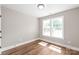 Bedroom has hardwood flooring, neutral walls, and bright natural light at 640 Central Nw Dr, Concord, NC 28027