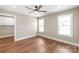 Bright bedroom features hardwood floors, a modern ceiling fan, and well-lit windows at 640 Central Nw Dr, Concord, NC 28027