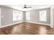 Bright and spacious bedroom featuring hardwood floors, three large windows, and neutral walls at 640 Central Nw Dr, Concord, NC 28027