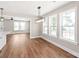 Open concept dining room boasts new hardwood floors and bright lighting at 640 Central Nw Dr, Concord, NC 28027