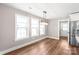 Bright dining room has new hardwood floors, modern lighting, and stainless refrigerator at 640 Central Nw Dr, Concord, NC 28027