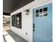 Close-up of a light blue front door with black hardware, black window shutters, and the house number displayed at 640 Central Nw Dr, Concord, NC 28027