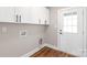 Bright laundry room featuring white cabinets and a white exterior door at 640 Central Nw Dr, Concord, NC 28027
