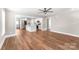 Open-concept living room with hardwood floors, a ceiling fan, and a view into the kitchen at 640 Central Nw Dr, Concord, NC 28027