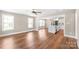 Bright living space with an open layout, hardwood floors, lots of natural light, and a view into the kitchen at 640 Central Nw Dr, Concord, NC 28027