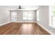 Inviting living room featuring hardwood floors, neutral paint, lots of natural light, and a ceiling fan at 640 Central Nw Dr, Concord, NC 28027