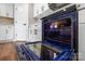 Oven with blue interior, white cabinets, and hardwood flooring at 640 Central Nw Dr, Concord, NC 28027