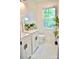 Bright and modern bathroom featuring white vanities, herringbone tile floors, and a large window at 645 Wilshire Sw Ave, Concord, NC 28027