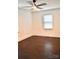Bedroom featuring hardwood floors, a ceiling fan, and natural light from the window at 645 Wilshire Sw Ave, Concord, NC 28027