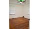 Cozy bedroom with hardwood floors, a ceiling fan, and natural light from the windows at 645 Wilshire Sw Ave, Concord, NC 28027