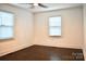 Bright bedroom with hardwood floors and natural light from the two windows at 645 Wilshire Sw Ave, Concord, NC 28027