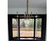 Close-up of bay windows and an elegant chandelier illuminating the cozy dining area at 645 Wilshire Sw Ave, Concord, NC 28027