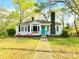 Charming single-story home featuring a bright blue front door, bay window, and a well-manicured lawn at 645 Wilshire Sw Ave, Concord, NC 28027
