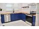 Modern kitchen with blue cabinets, butcher block countertops, stainless steel appliances, and stylish backsplash at 645 Wilshire Sw Ave, Concord, NC 28027