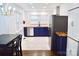 Modern, fully-equipped kitchen featuring blue cabinets, stainless steel appliances and hardwood floors at 645 Wilshire Sw Ave, Concord, NC 28027