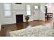 Bright living room with hardwood floors, decorative fireplace, and an arched entrance to the dining area at 645 Wilshire Sw Ave, Concord, NC 28027