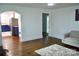 Open-concept living room with hardwood floors, access to the kitchen and ample space for furniture at 645 Wilshire Sw Ave, Concord, NC 28027