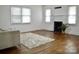 Spacious living room with hardwood floors, a decorative fireplace, and large windows for plenty of natural light at 645 Wilshire Sw Ave, Concord, NC 28027