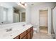 Bright bathroom featuring a double sink vanity with wood cabinets, large mirror, and a toilet room at 726 Centennial St, Gastonia, NC 28056
