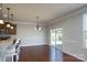 An open-concept dining area features hardwood floors, chair railing, and sliding glass doors at 726 Centennial St, Gastonia, NC 28056