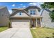 Charming two-story home featuring a stone facade, a two-car garage, and a well-maintained front lawn at 726 Centennial St, Gastonia, NC 28056