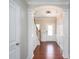 Inviting foyer with hardwood floors, an arched doorway, and views of the staircase and front door at 726 Centennial St, Gastonia, NC 28056