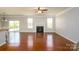 Bright living room featuring hardwood floors, a fireplace, and sliding glass doors to the backyard at 726 Centennial St, Gastonia, NC 28056