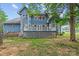 Lovely shot of the home's backyard featuring a spacious back deck and fenced yard at 7887 Mountain Shore Dr, Sherrills Ford, NC 28673