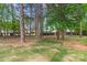 Lush backyard surrounded by mature trees and privacy landscaping at 7887 Mountain Shore Dr, Sherrills Ford, NC 28673