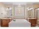 Luxurious bathroom with a soaking tub, double vanity, decorative window, and tiled shower at 7887 Mountain Shore Dr, Sherrills Ford, NC 28673