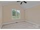 Spacious bedroom with a window, neutral walls, carpet, and fan at 7887 Mountain Shore Dr, Sherrills Ford, NC 28673