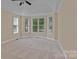 Bright bedroom with a trey ceiling, a ceiling fan, carpet, and lots of natural light from the multiple windows at 7887 Mountain Shore Dr, Sherrills Ford, NC 28673