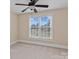 Bright bedroom with neutral carpet, ceiling fan, and window view of the outdoors at 7887 Mountain Shore Dr, Sherrills Ford, NC 28673