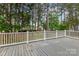 View of spacious deck and backyard area with mature trees providing a private outdoor space at 7887 Mountain Shore Dr, Sherrills Ford, NC 28673