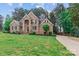 Beautiful brick home featuring a well-manicured lawn and a charming side-entry driveway at 7887 Mountain Shore Dr, Sherrills Ford, NC 28673