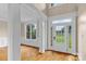 Bright foyer featuring hardwood floors, elegant columns, and a glass-paneled front door at 7887 Mountain Shore Dr, Sherrills Ford, NC 28673