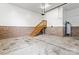 Spacious garage featuring a brick base, stairs to second level, and concrete flooring at 7887 Mountain Shore Dr, Sherrills Ford, NC 28673