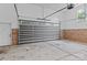 Spacious garage featuring an insulated garage door, brick base, and concrete flooring at 7887 Mountain Shore Dr, Sherrills Ford, NC 28673
