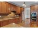 Kitchen featuring wooden cabinetry, granite countertops, and stainless steel appliances, all beautifully lit at 7887 Mountain Shore Dr, Sherrills Ford, NC 28673