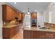 Well-equipped kitchen with wood cabinets, granite countertops, and stainless steel appliances at 7887 Mountain Shore Dr, Sherrills Ford, NC 28673