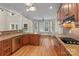 Open kitchen with hardwood floors, stainless steel appliances, and an adjacent eating area bathed in natural light at 7887 Mountain Shore Dr, Sherrills Ford, NC 28673