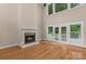 Inviting living room with a cozy fireplace, hardwood floors, and French doors to outdoor space at 7887 Mountain Shore Dr, Sherrills Ford, NC 28673