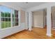 Bright living room with hardwood floors, wainscoting, and large windows with backyard views at 7887 Mountain Shore Dr, Sherrills Ford, NC 28673